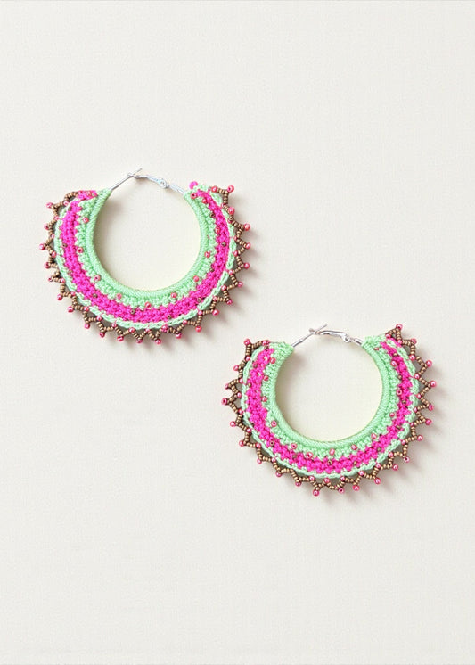 Neon green and hot pink crochet hoop earrings with gold and pink beads by ThatRomeo on a light background.
