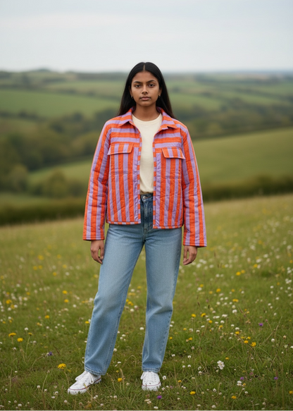 Model wearing ThatRomeo’s Sunset Stripe Quilted Jacket — orange and lavender striped cotton jacket with collar and pockets.