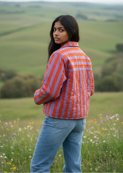 Model wearing ThatRomeo’s Sunset Stripe Quilted Jacket — orange and lavender striped cotton jacket with collar and pockets.