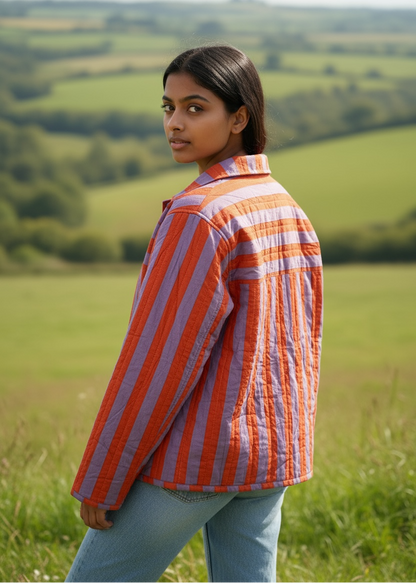 Model wearing ThatRomeo’s Sunset Stripe Quilted Jacket — orange and lavender striped cotton jacket with collar and pockets.