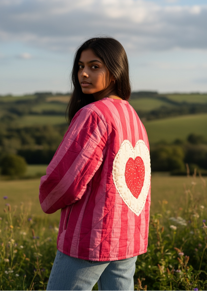 Model wearing ThatRomeo’s Sweetheart Patch Quilted Jacket — pink striped cotton jacket with heart patches and relaxed open front.