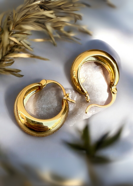 Shop Goldie by That Romeo – sculptural brass teardrop hoops made for everyday elegance. Bold, polished, and beautifully versatile.